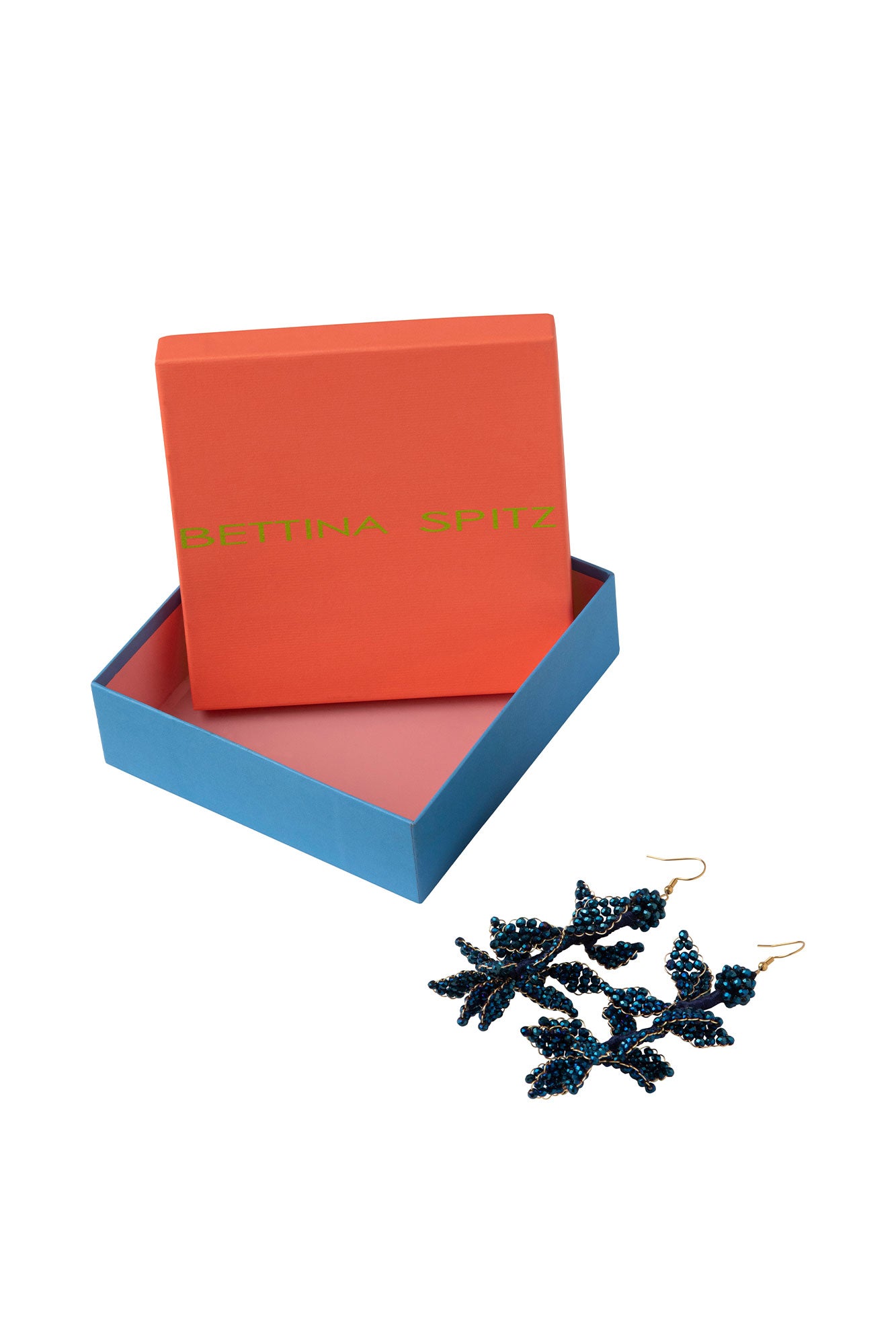 Blue beaded branching earrings beside an orange and blue Bettina Spitz box