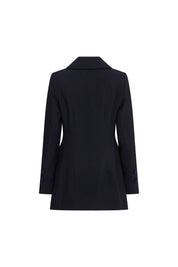 The Blazer Botón Rosa — full back view showing clean structured navy crepe silhouette with two back waist darts, centered back vent, navy velvet trim band at each cuff, and shaped hip flare