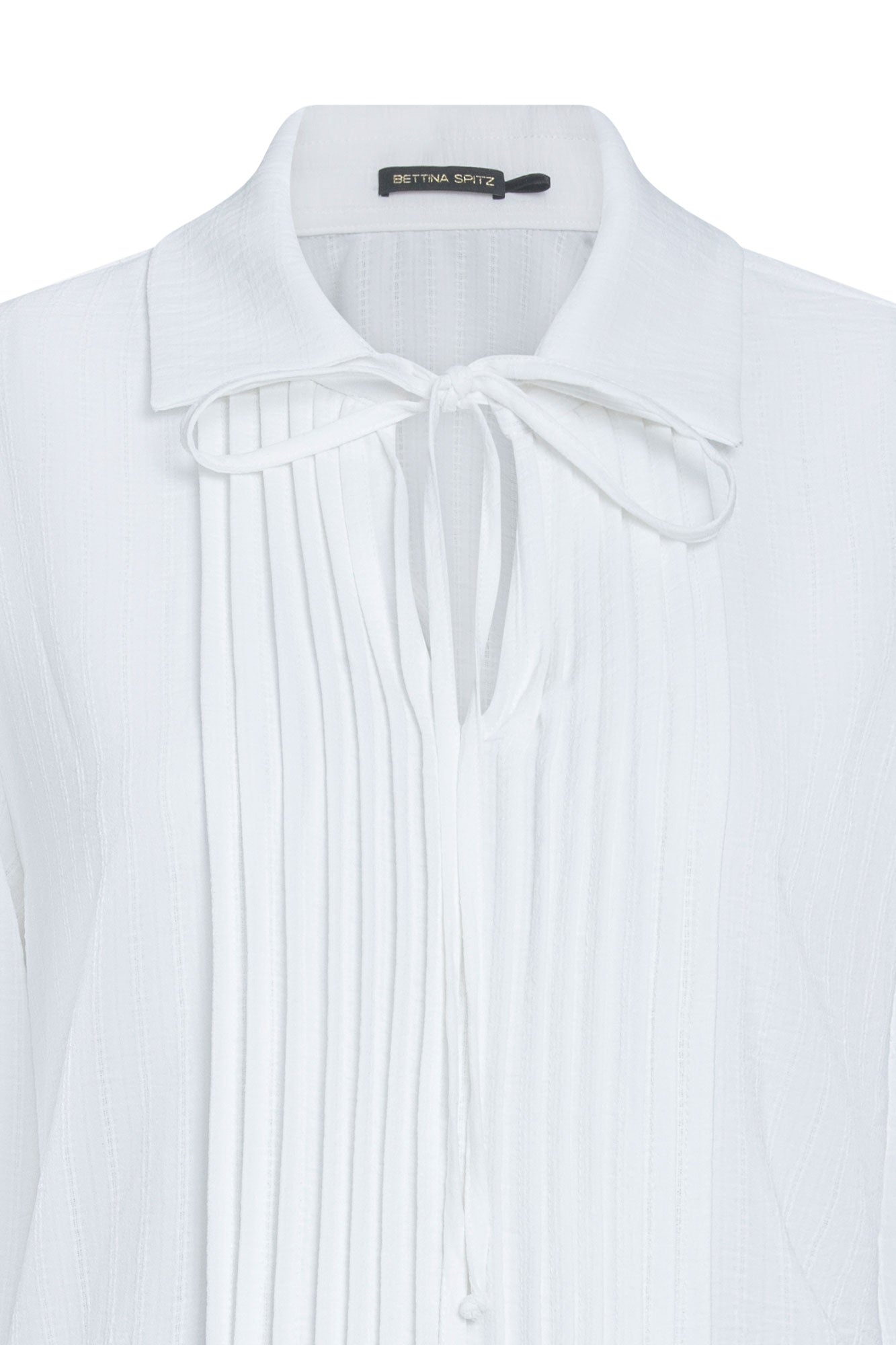 Close-up of ivory blouse showing front pintucks, pointed collar and narrow neck tie