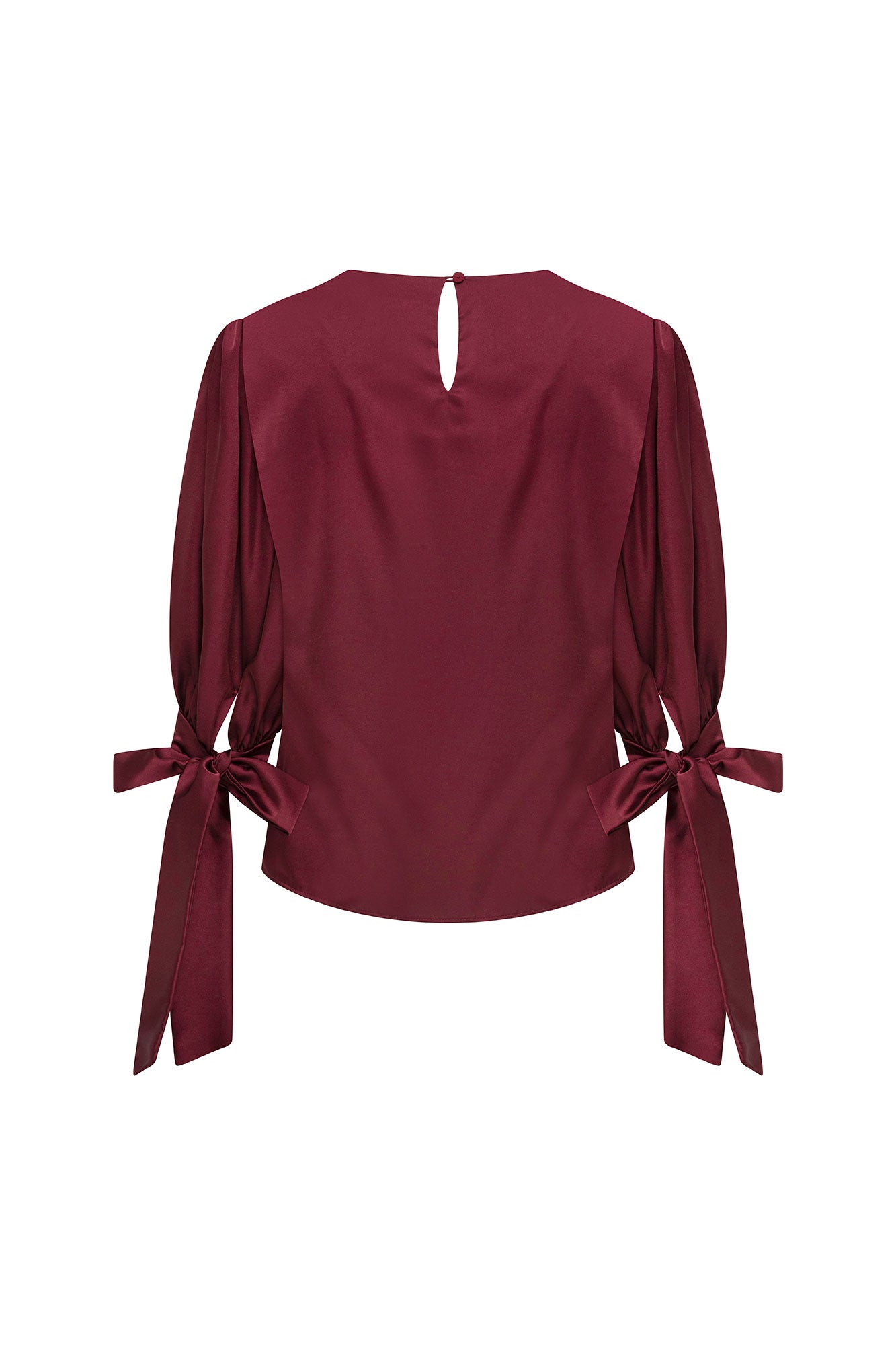 Back view of burgundy puff-sleeve blouse with buttoned keyhole closure and bow cuff ties