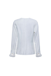 The Nácar White Ruffle-Placket Blouse — back view with layered ruffle cuffs