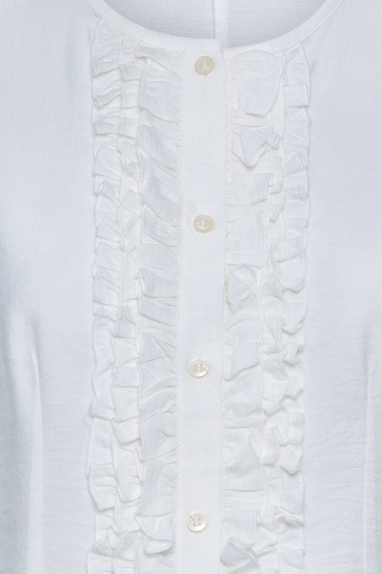 The Nácar White Ruffle-Placket Blouse — detail of ruched ruffle placket and pearl buttons