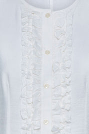 The Nácar White Ruffle-Placket Blouse — detail of ruched ruffle placket and pearl buttons