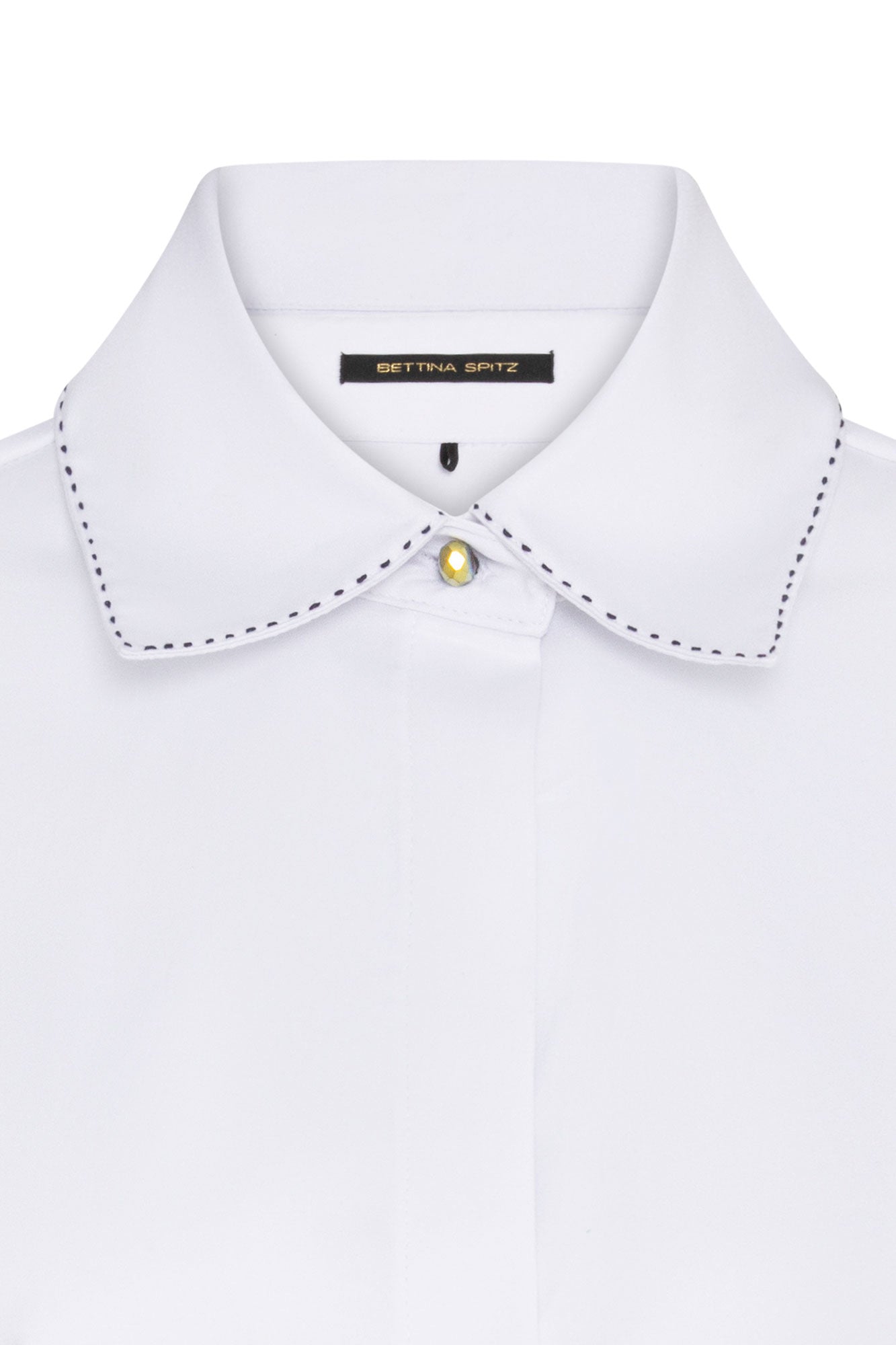 The Sol Flor White Shirt — close-up of hand-embroidered wildflower sleeve detail with multi-colour thread and bead embroidery
