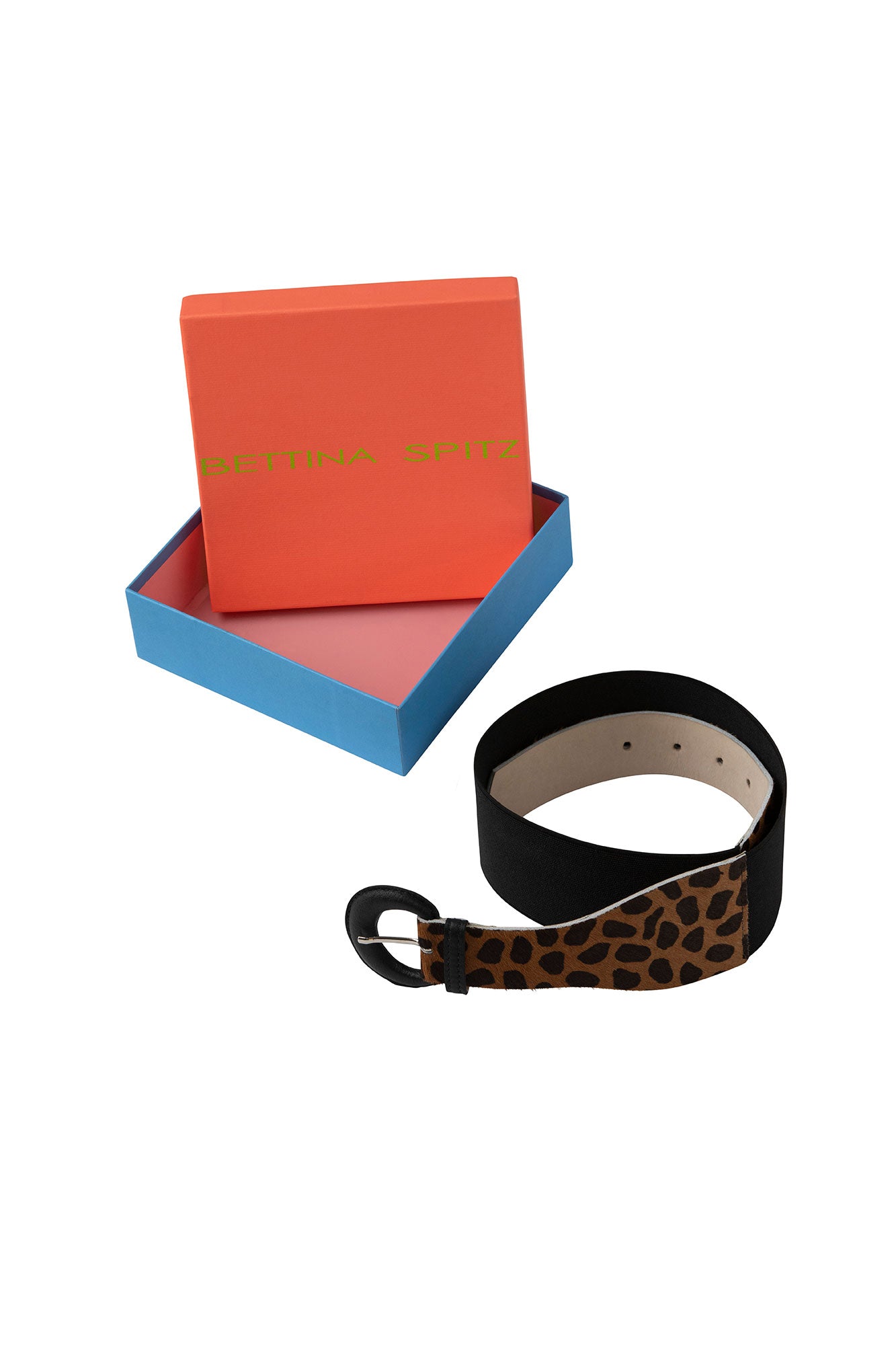 Black animal-print waist belt showing buckle and adjustment holes beside a Bettina Spitz box