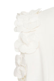 Crop Sisa Flores Ivory — close-up of armhole edge showing tightly placed hand-applied 3D ivory fabric flowers, each one individually gathered and shaped into a full dimensional bloom, forming a continuous floral border along the entire armhole