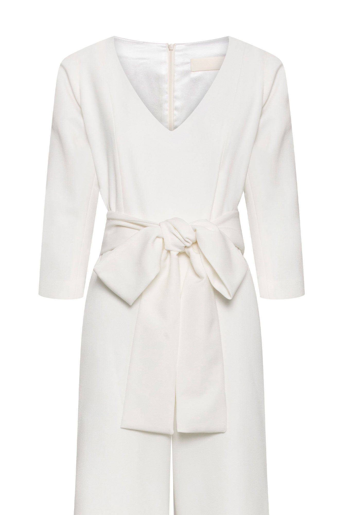 The Enterizo V Ivory Wide-Leg Jumpsuit — close-up of self-fabric tie belt bow and V-neckline button detail