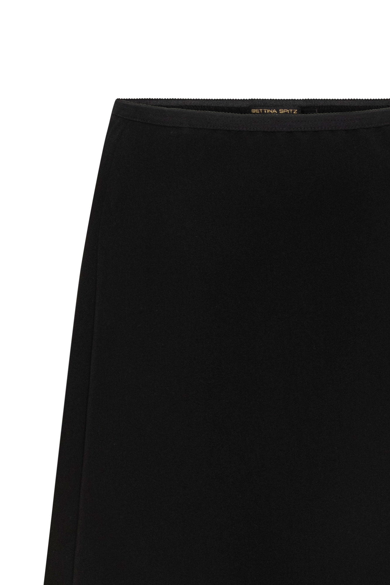 Close-up of black skirt showing narrow ribbon waistband and plain fabric