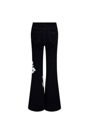 The Jean Campana Flor Hilo Navy — full back view showing five-pocket dark navy stretch denim flare jeans with contrast topstitching, Bettina Spitz label at inner waistband, and white botanical embroidery visible on back left flare panel