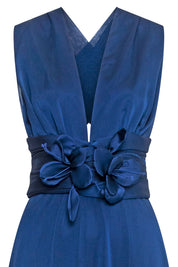 The Orquídea Royal Blue Maxi Dress — detail of satin floral appliqués at waist