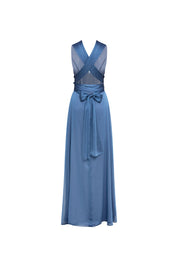 Back view of blue maxi dress with crossed panels, open-back detail and long waist ties tied in a bow