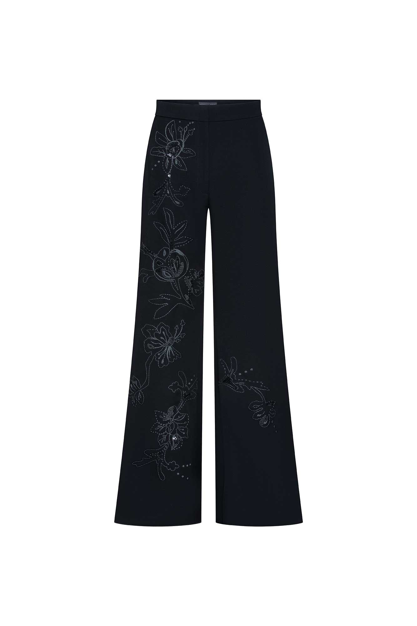 The Gaby Black Wide-Leg Trousers — full front view showing wide-leg flare silhouette and hand-embroidered botanical vine on left leg