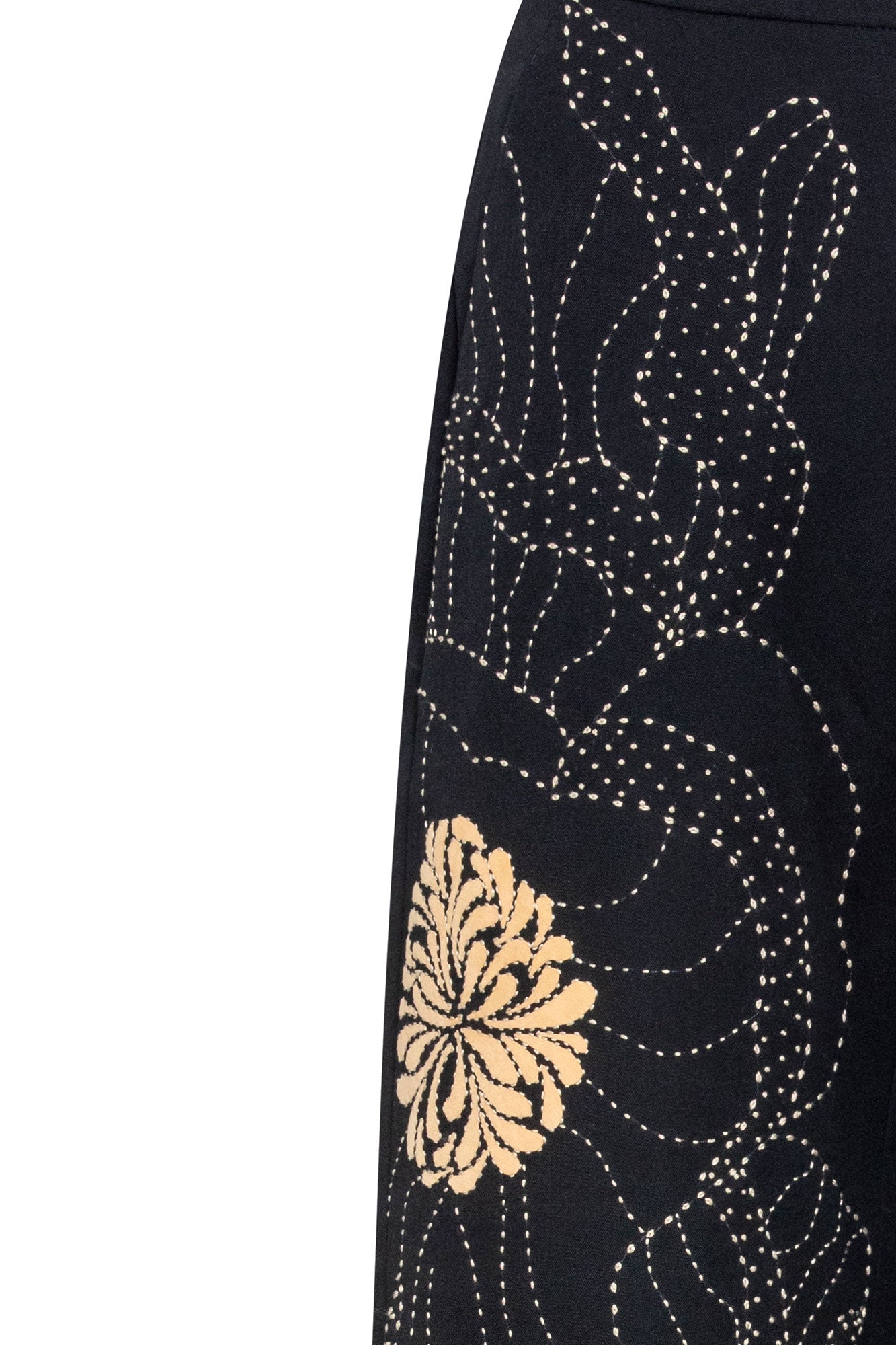 The Milo Black Wide-Leg Pants — close-up detail of dotted stitch floral embroidery and golden chrysanthemum