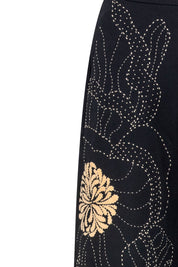 The Milo Black Wide-Leg Pants — close-up detail of dotted stitch floral embroidery and golden chrysanthemum