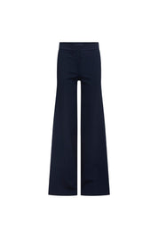 Pantalón Patch Ancho Navy — full front view showing high-rise navy wide-leg flared trousers in smooth structured fabric with clean waistband, concealed front placket, center-front crease, and dramatic wide flare from hip to floor-length hem