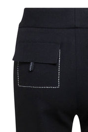The Patch Campana — close-up of back mid-thigh cargo patch pocket with fold-over flap, gold D-ring hardware detail and white contrast topstitching edge against black structured fabric