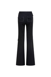 The Patch Campana — full back view showing two large mid-thigh cargo patch pockets with fold-over flaps and white contrast topstitching, and clean flare silhouette from knee to floor