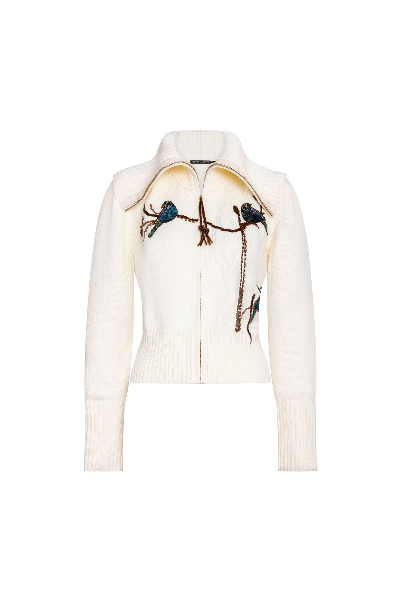 The Azulejos Ivory Knit Zip Jacket — full front view with gold zipper and three dimensional hand-embroidered kingfisher bird appliqués on branch vine