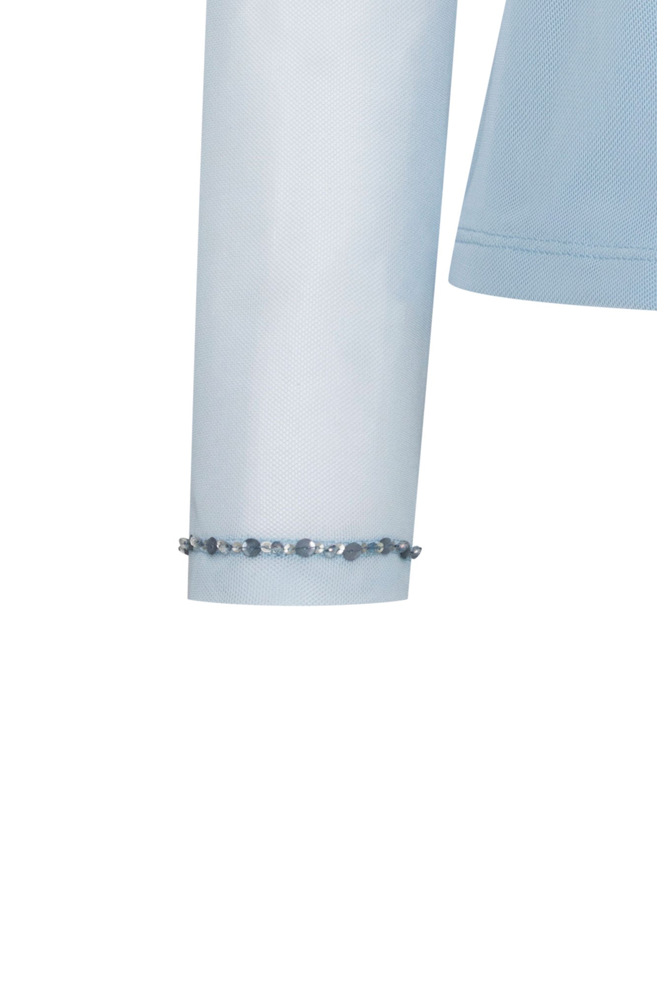 Detail of sheer sky-blue mesh sleeve with a fine row of sparkling embellishments at the cuff