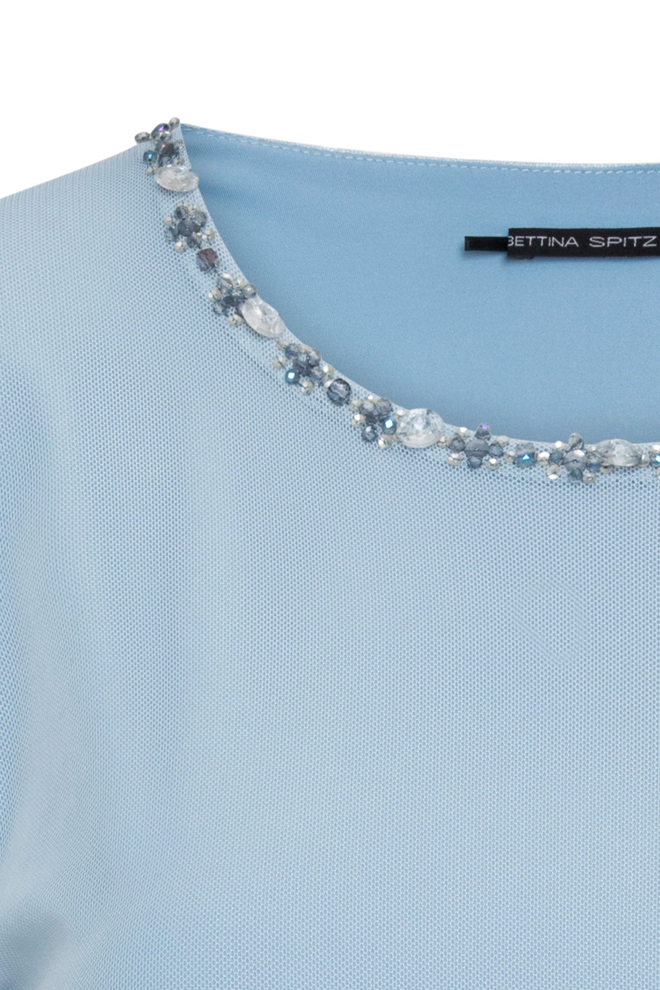 Close-up of sky-blue top neckline with clear and blue-grey faceted embellishments