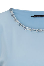 Close-up of sky-blue top neckline with clear and blue-grey faceted embellishments